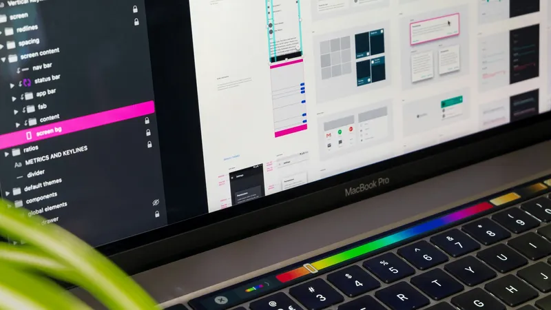 A laptop with an open app screen design program, showing layers and components on the display